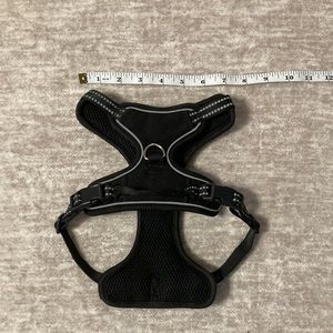 Black dog harness with reflective detail. Front and back clip.
